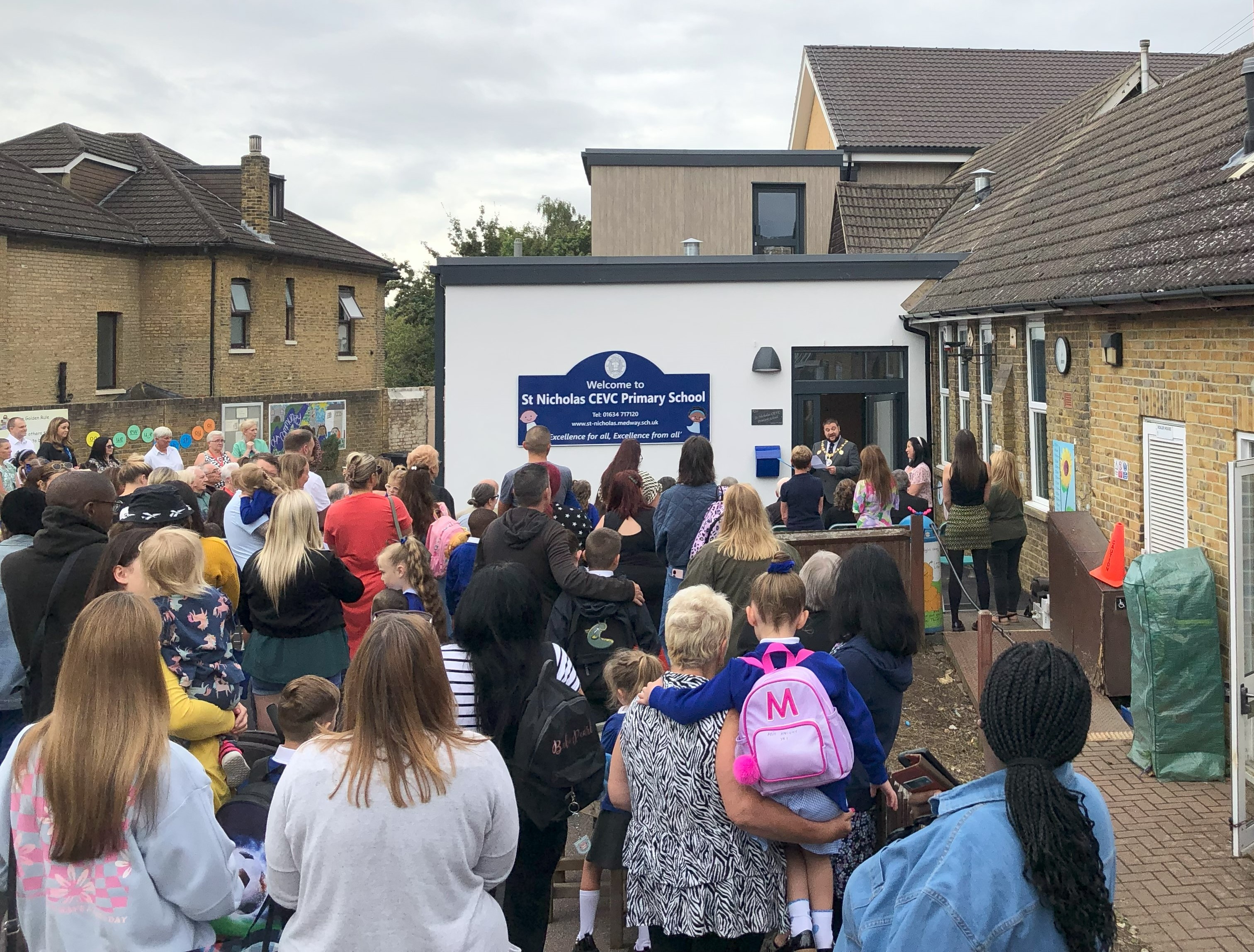 The school community gathers on the school playground