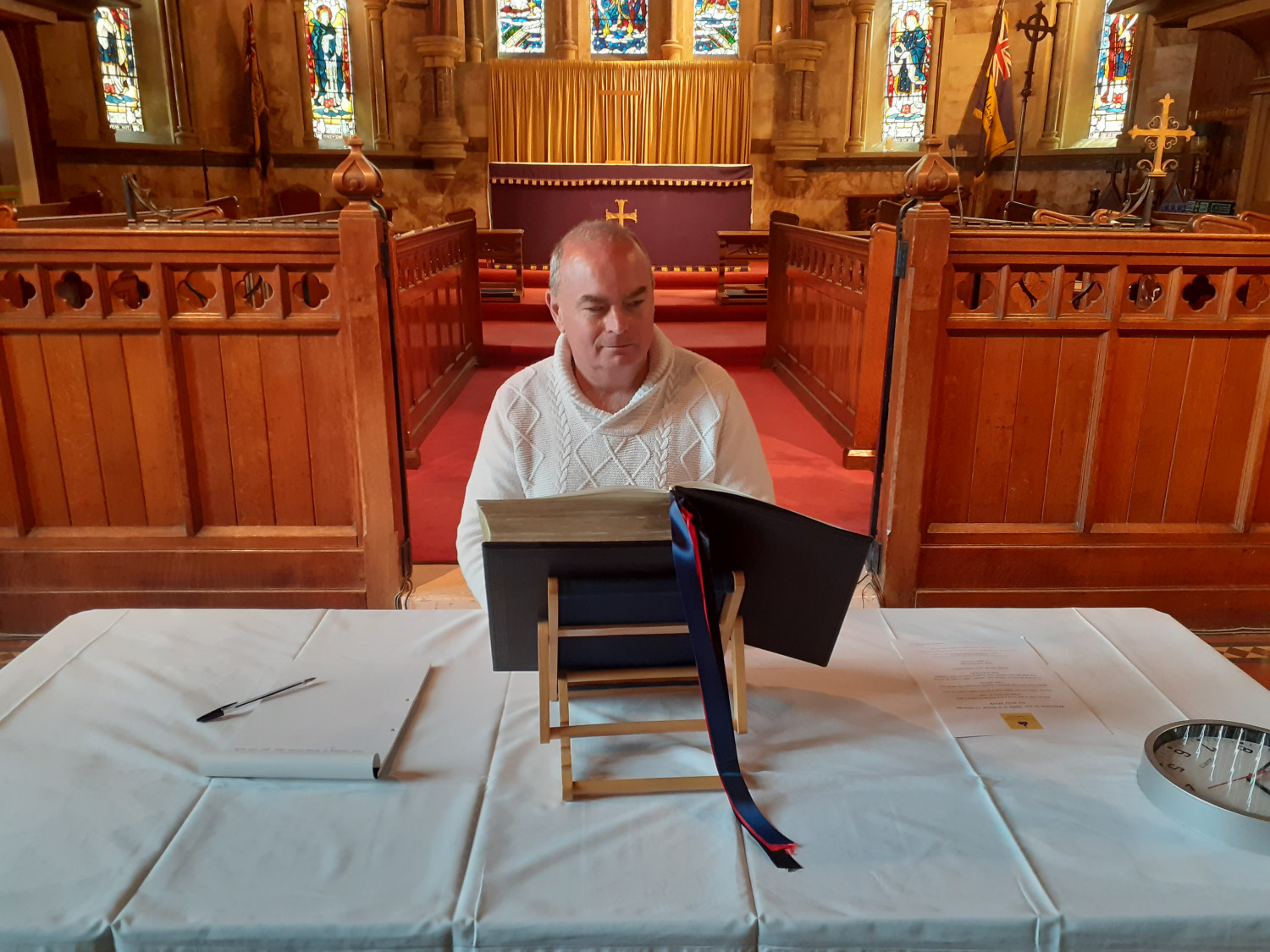 Parishioner Richard gets ready to read the Bible